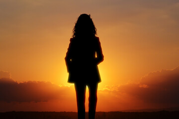 Hope. Silhouette of woman under beautiful sky at sunset, double exposure