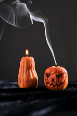 Halloween-style candles on a dark background. Festive decor.