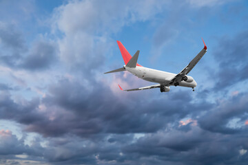 Airplane flying in beautiful blue sky with clouds