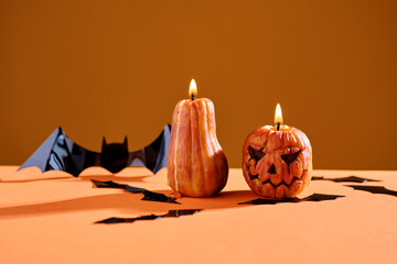 Halloween-style candles on a orange background. Festive decor.