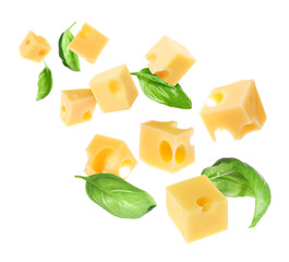 Cheese cubes and green basil leaves flying against white background