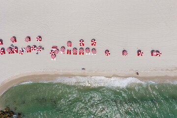 Sea relax under beach umbrella. Travel to sea. Aerial top view of sand beach with turquoise water....