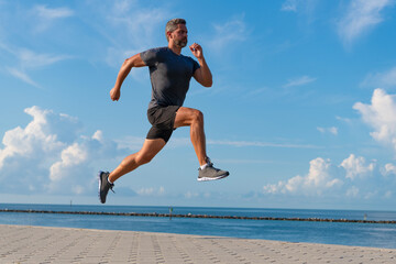 Sport lifestyle. Sportsman running in summer. Sport runner training outdoor. Healthy lifestyle with...