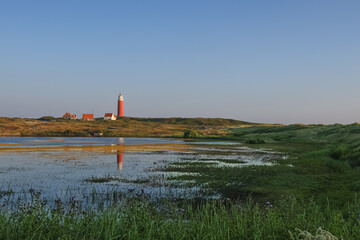 Texel in the Netherlands, Lighthouse, lake, reflection of the lighthouse in the lake, nature reserve