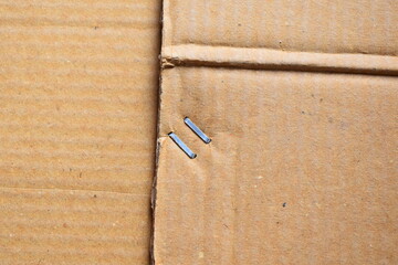 Metal staple on brown cardboard