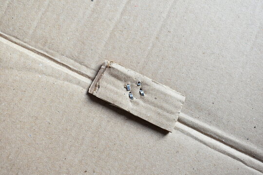 Metal staple on brown cardboard
