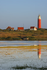 Portraitformat, Texel in the Netherlands, Lighthouse, lake, reflection of the lighthouse in the lake, nature reserve