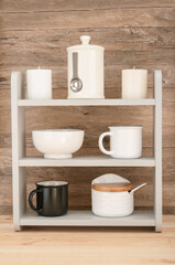 Wooden shelf with different kitchen utensil