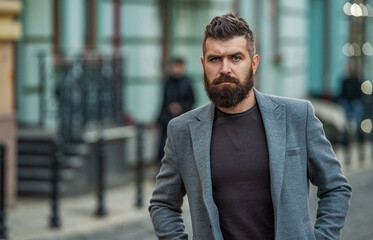 Businessman in the city. City street with business man. Man style fashion. Stylish and brutal man...
