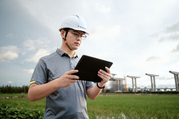 asian male engineer working in construction site for bridge