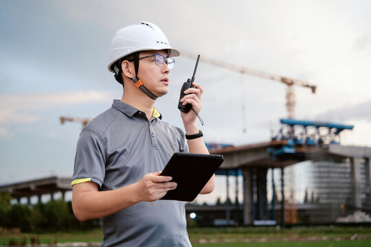 asian male engineer working in construction site for bridge - Powered by Adobe