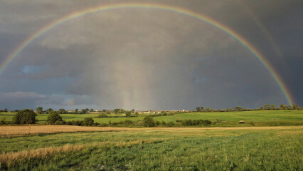 Rainbow stretching across open fields