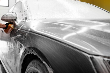 Hand Washing Car with Sponge. Washing car manually with sponge and foam provides effective paint...
