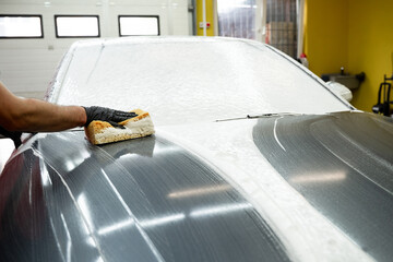 Hand Washing Car with Sponge. Washing car manually with sponge and foam provides effective paint...