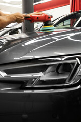 Car paint correction and polishing. Polishing machine expertly removes paint swirls and oxidation...