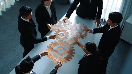 Top view of smart business people gather wooden cog together at meeting. Group of project manager...
