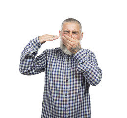 Mature man disgusted by a bad smell, covering his nose and mouth