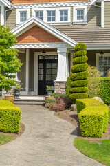 Obraz premium Entrance of painted luxury house in spring with stair steps and nice landscape in Vancouver, Canada, North America. Day time on May 2025.