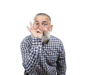 Mature man making a silence gesture, pressing his index finger to his lips