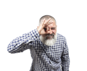 Bearded mature man making an ok gesture with fingers and looking through it with a curious expression