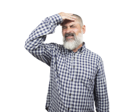Senior man with beard and checkered shirt suffering from headache, showing frustration and regret for having made a mistake
