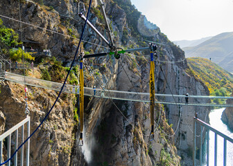 ziplining site in the canyon against the backdrop of the rope bridge between the mountains