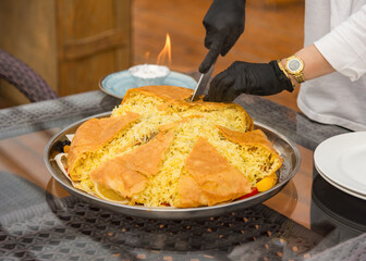 serving Shah pilaf to tourists in an oriental restaurant
