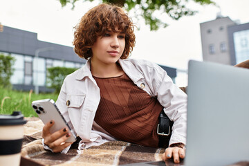 Young woman embraces remote work in a serene green park during summer days
