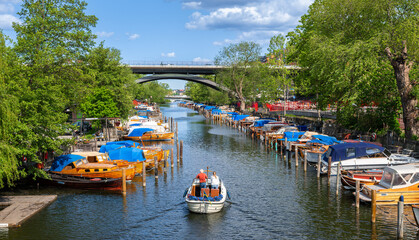 Scenic Canal View in Stockholm with Colorful Boats and Bridge