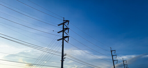 High Voltage Power Lines and Electric Poles with Clear Blue Sky Background