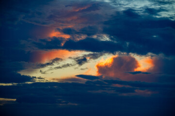 sunset in the orange and dark blue  clouds