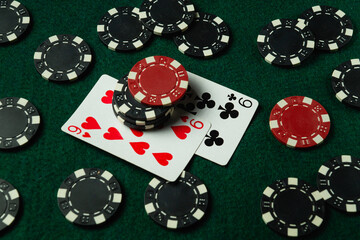 A lively card game takes place featuring poker chips in red and black, scattered across a green...