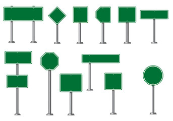 A collection of various green road signs with different shapes on metal poles against a white background
