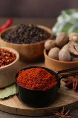 Different aromatic spices on wooden table, closeup