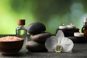 Composition with spa stones on grey table, closeup