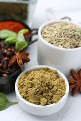 Different aromatic spices on white table, closeup
