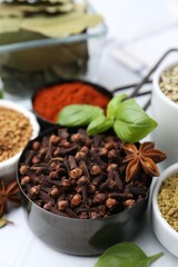 Different aromatic spices on white table, closeup