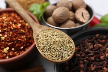 Different aromatic spices on white table, closeup