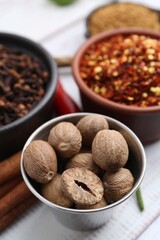 Different aromatic spices on white table, closeup