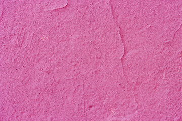 Distressed red pink plaster as a background.