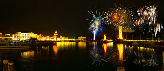 Panorama of the illuminated Lindau harbor on Lake Constance with fireworks Bavaria, Germany
