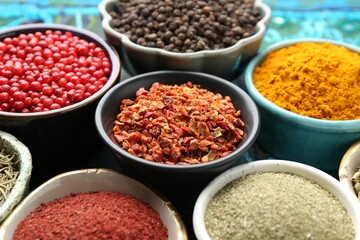 Different aromatic spices on blue tablecloth, closeup