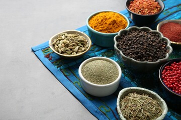 Different aromatic spices on grey table, closeup