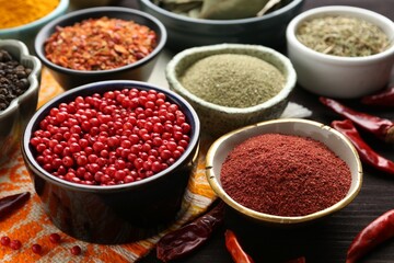 Different aromatic spices on wooden table, closeup