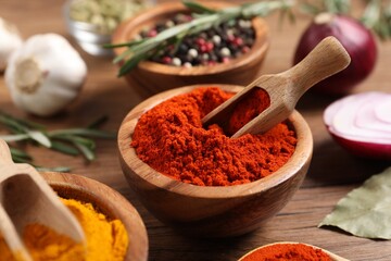 Different aromatic spices on wooden table, closeup