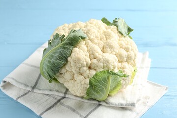 Whole cauliflower on light blue wooden table, closeup
