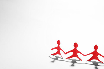 Paper figures of people holding hands on white background, space for text