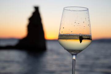 glass of Albariño wine with the San Sadurniño tower in the background. Sunset, Cambados