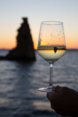 glass of Albariño wine with the San Sadurniño tower in the background. Sunset, Cambados