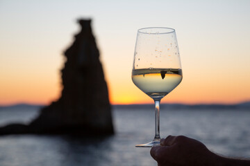 glass of Albariño wine with the San Sadurniño tower in the background. Sunset, Cambados